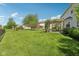 Expansive backyard featuring a well-maintained lawn, mature trees, and a cozy patio area at 14162 Nicholas Dr, Carmel, IN 46074