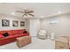 Finished basement featuring neutral walls, plush carpet, and a cozy seating area with a vibrant red sofa at 14162 Nicholas Dr, Carmel, IN 46074
