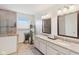Dual sink bathroom with granite countertops, a large walk-in shower, and natural light at 14162 Nicholas Dr, Carmel, IN 46074