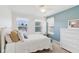 Bright bedroom features a bed, side table, and three sunny windows at 14162 Nicholas Dr, Carmel, IN 46074