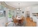The bright dining area features a round table and seating for 5 near sliding glass doors and a window at 14162 Nicholas Dr, Carmel, IN 46074
