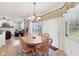 Bright dining area features a round table with seating and an elegant chandelier, blending seamlessly with the living room at 14162 Nicholas Dr, Carmel, IN 46074