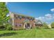 Beautiful two-story brick home on a spacious lot with lush green lawn and mature trees at 14162 Nicholas Dr, Carmel, IN 46074