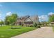 Spacious brick home with a large front yard and a long driveway leading to the property at 14162 Nicholas Dr, Carmel, IN 46074