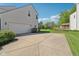 Home with attached garage, spacious driveway and green lawn in a beautiful suburban setting at 14162 Nicholas Dr, Carmel, IN 46074