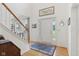 Bright foyer with hardwood floors, a staircase, and a white front door at 14162 Nicholas Dr, Carmel, IN 46074