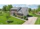 Beautiful home with brick facade, manicured lawn, and a paved driveway leads to a two-car garage at 14162 Nicholas Dr, Carmel, IN 46074