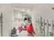 Hallway featuring whimsical mural of a fence and window with beautiful botanical and wildlife imagery at 14162 Nicholas Dr, Carmel, IN 46074