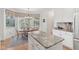 Bright dining area near kitchen featuring a round wooden table and chairs, bathed in natural light from the windows at 14162 Nicholas Dr, Carmel, IN 46074