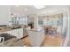 Open-concept kitchen with granite counters and stainless steel appliances overlooking a dining area with wood floors at 14162 Nicholas Dr, Carmel, IN 46074