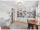 Cozy living room boasts built-in shelving, a comfortable armchair, and a refined desk setup, blending relaxation and work at 14162 Nicholas Dr, Carmel, IN 46074