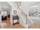 Elegant staircase with hardwood floors leading to upper level, next to a large bookcase at 14162 Nicholas Dr, Carmel, IN 46074