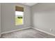 Cozy bedroom with neutral walls and carpeting, illuminated by natural light streaming through a window at 15004 Stonneger St, Westfield, IN 46074