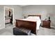 Comfortable bedroom features soft carpet, a wood bed frame, and a walk-in closet, creating a relaxing retreat at 15004 Stonneger St, Westfield, IN 46074