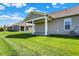 Covered patio next to a lush green lawn, perfect for relaxing or entertaining outside at 15004 Stonneger St, Westfield, IN 46074