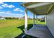 View from a covered patio of a home overlooking a green lawn and mature trees at 15004 Stonneger St, Westfield, IN 46074