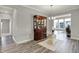 Elegant dining room with a unique glass table, decorative cabinet, and a view to the exterior at 15004 Stonneger St, Westfield, IN 46074