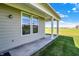 View of home's exterior with patio, overlooking grassy yard; ideal for outdoor living at 15004 Stonneger St, Westfield, IN 46074
