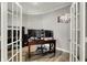 Open office space with two computer monitors, a wooden desk, and French doors for an airy feel at 15004 Stonneger St, Westfield, IN 46074