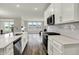 Modern kitchen with white cabinets, subway tile backsplash, and stainless appliances at 15004 Stonneger St, Westfield, IN 46074