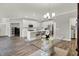 Modern kitchen featuring stainless steel appliances, white cabinets, a center island, and hardwood floors at 15004 Stonneger St, Westfield, IN 46074