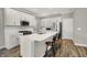 Bright kitchen boasts white cabinets, stainless appliances, and an island with bar seating at 15004 Stonneger St, Westfield, IN 46074