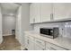 Close-up view of kitchen features white cabinets, subway tile backsplash, and modern microwave at 15004 Stonneger St, Westfield, IN 46074