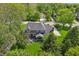 Aerial view of home with manicured lawn, brick chimney and outdoor seating area at 1508 Redwood Dr, Carmel, IN 46032