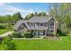 An aerial view of a two-story home showcasing its mature landscaping and traditional architectural details at 1508 Redwood Dr, Carmel, IN 46032