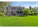 Manicured backyard showcasing a screened-in porch, patio set, and verdant lawn at 1508 Redwood Dr, Carmel, IN 46032