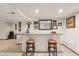 Basement wet bar featuring a mirror, stool seating, and decor at 1508 Redwood Dr, Carmel, IN 46032