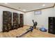 Basement workout area with wood flooring, a rowing machine, and a storage unit at 1508 Redwood Dr, Carmel, IN 46032