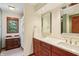A modern bathroom features a double vanity with wooden cabinets and large mirror to the right at 1508 Redwood Dr, Carmel, IN 46032