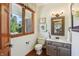 Cozy half bathroom with neutral walls, a dark wood window and vanity at 1508 Redwood Dr, Carmel, IN 46032
