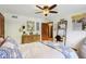 This bedroom features a full-sized bed with a ceiling fan, desk and a dark wooden dresser at 1508 Redwood Dr, Carmel, IN 46032