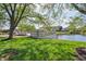 Community space with lake access, featuring benches, trees, and a well-manicured lawn at 1508 Redwood Dr, Carmel, IN 46032