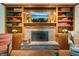 Living room fireplace with wood trim built-ins and shelving at 1508 Redwood Dr, Carmel, IN 46032