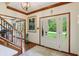 Bright foyer with hardwood floors, staircase, and a view of the front yard through the glass-paneled front door at 1508 Redwood Dr, Carmel, IN 46032
