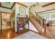 Elegant foyer featuring hardwood floors, a staircase with wrought iron railing, and a decorative bookshelf at 1508 Redwood Dr, Carmel, IN 46032