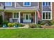 Inviting front porch with rocking chairs, lush plants, and decorative accents at 1508 Redwood Dr, Carmel, IN 46032