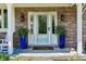 Welcoming front porch featuring a glass door, ornate planters, and a charming welcome mat for a warm entrance at 1508 Redwood Dr, Carmel, IN 46032