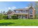 Beautiful two-story home with brick and siding, green lawn, and an inviting front porch with rocking chairs at 1508 Redwood Dr, Carmel, IN 46032