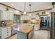 Eat-in kitchen with a window over the sink and a view into a carpeted den at 1508 Redwood Dr, Carmel, IN 46032