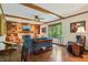 Cozy living room with a brick fireplace, built-in bookshelves, hardwood floors, and comfortable seating at 1508 Redwood Dr, Carmel, IN 46032
