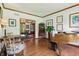 Open living room with hardwood floors and a view into the formal dining room at 1508 Redwood Dr, Carmel, IN 46032