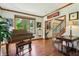 Bright and airy living room featuring a grand piano and refinished hardwood floors at 1508 Redwood Dr, Carmel, IN 46032
