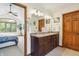 This main bathroom features a double vanity with dark wood cabinets that add a touch of elegance at 1508 Redwood Dr, Carmel, IN 46032