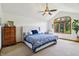 This main bedroom features a cathedral ceiling, chair and large window with backyard views at 1508 Redwood Dr, Carmel, IN 46032