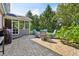 Paver patio with a table and chairs, surrounded by lush landscaping at 1508 Redwood Dr, Carmel, IN 46032