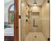 Walk-in shower with glass door and multi-spray showerhead. A tiled wall niche offer extra storage at 1508 Redwood Dr, Carmel, IN 46032